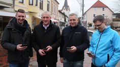 Die Antenne als kleiner weißer Kasten oben an der Straßenlampe fällt kaum auf, dafür ist die Freude von Bastian Grimm (Wirtschaftstreff), Christian Meyer-Hammerström, Sven Tienken und René Niesel (alle Osterholzer Stadtwerke) nicht zu übersehen.  Foto: eb