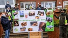 Landwirte überreichten ein Plakat mit der Aufschrift „Ohne Landwirtschaft ist alles doof“ an Bürgermeister Guido Dieckmann und Claudia Lühmann (hinten).  Foto: kh